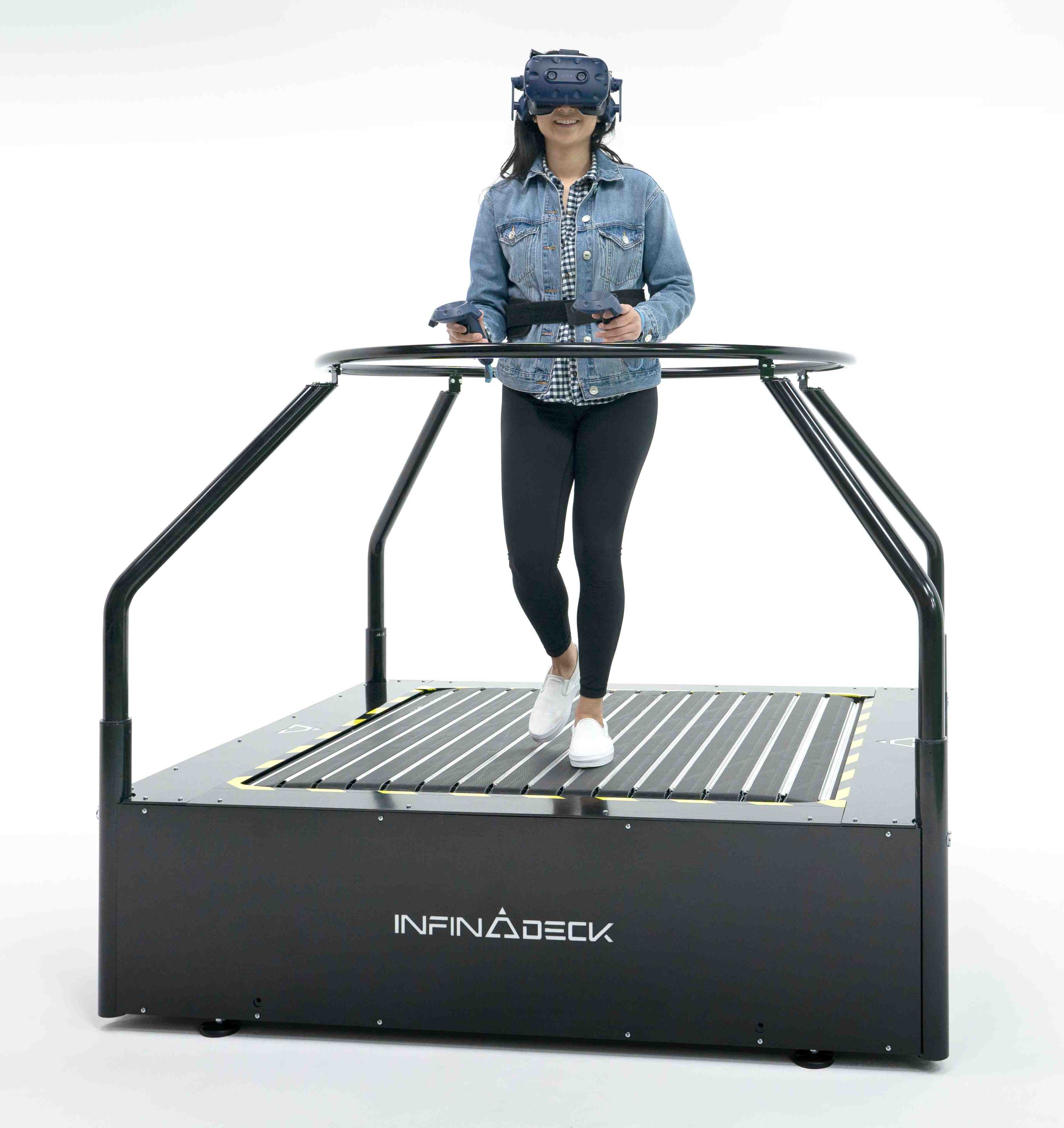 Woman using an Infinadeck with a VR headset on